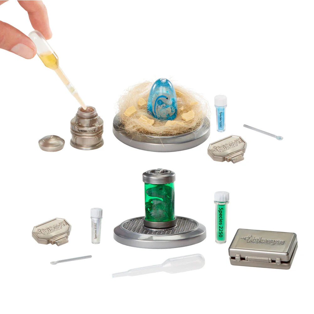 Hand dipping stick into egg in mini dino kit; test tubes, canister and tools