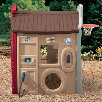 Children's red and tan playhouse playset with front panel door, window, and tire