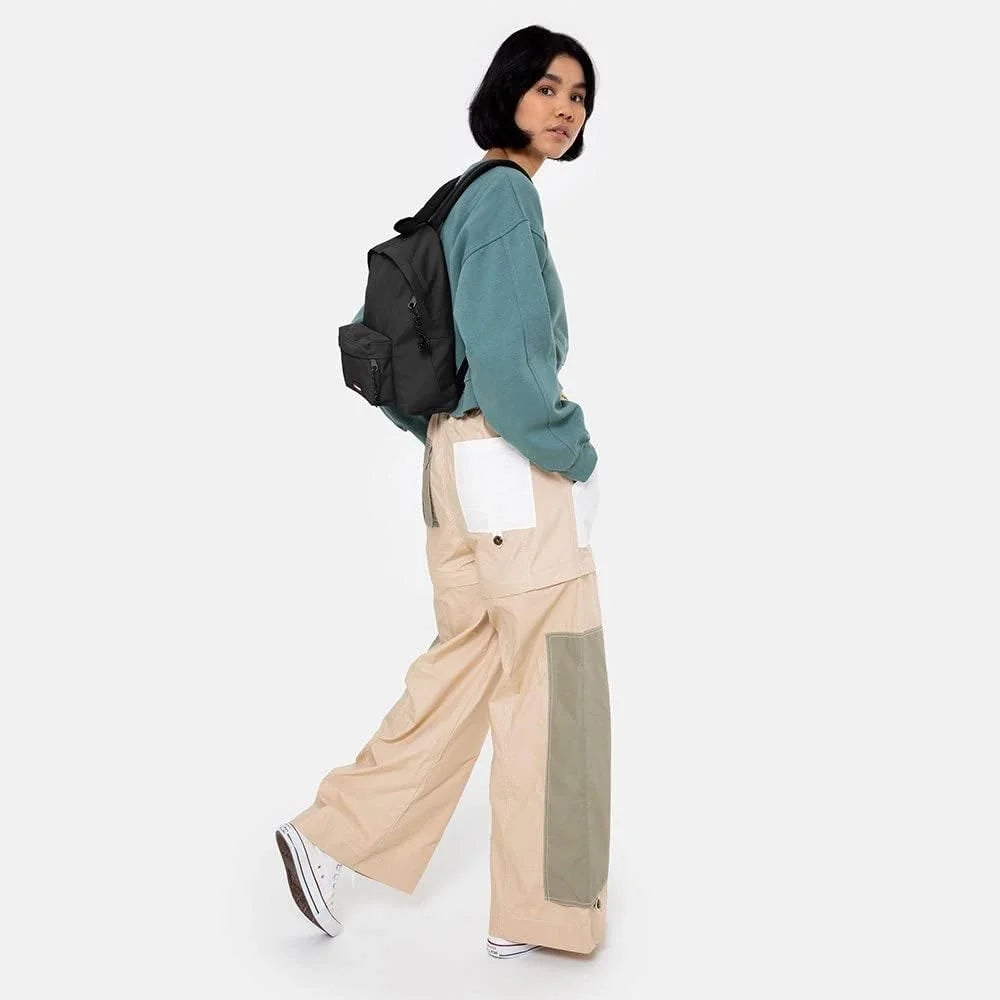 Eastpak Orbit XS black mini backpack worn on side, front pocket and small zipper pulls