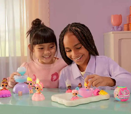 Toy fairy set with small dolls on table, children smiling while playing