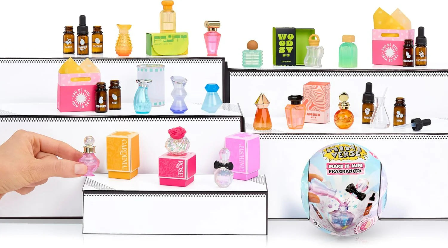 Mini fragrance display kit with shelves of small bottles in pink, green, and orange