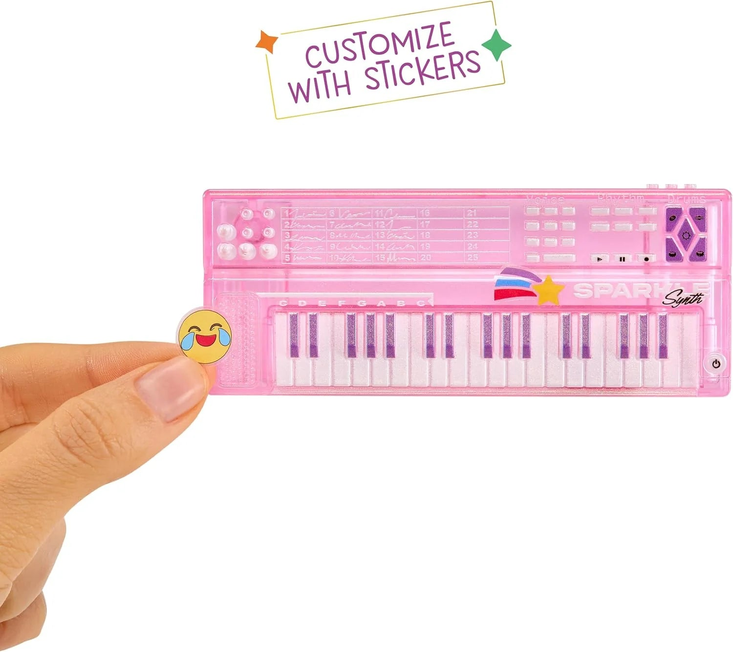 Pink keyboard toy with stickers, hand holding showing keys and controls