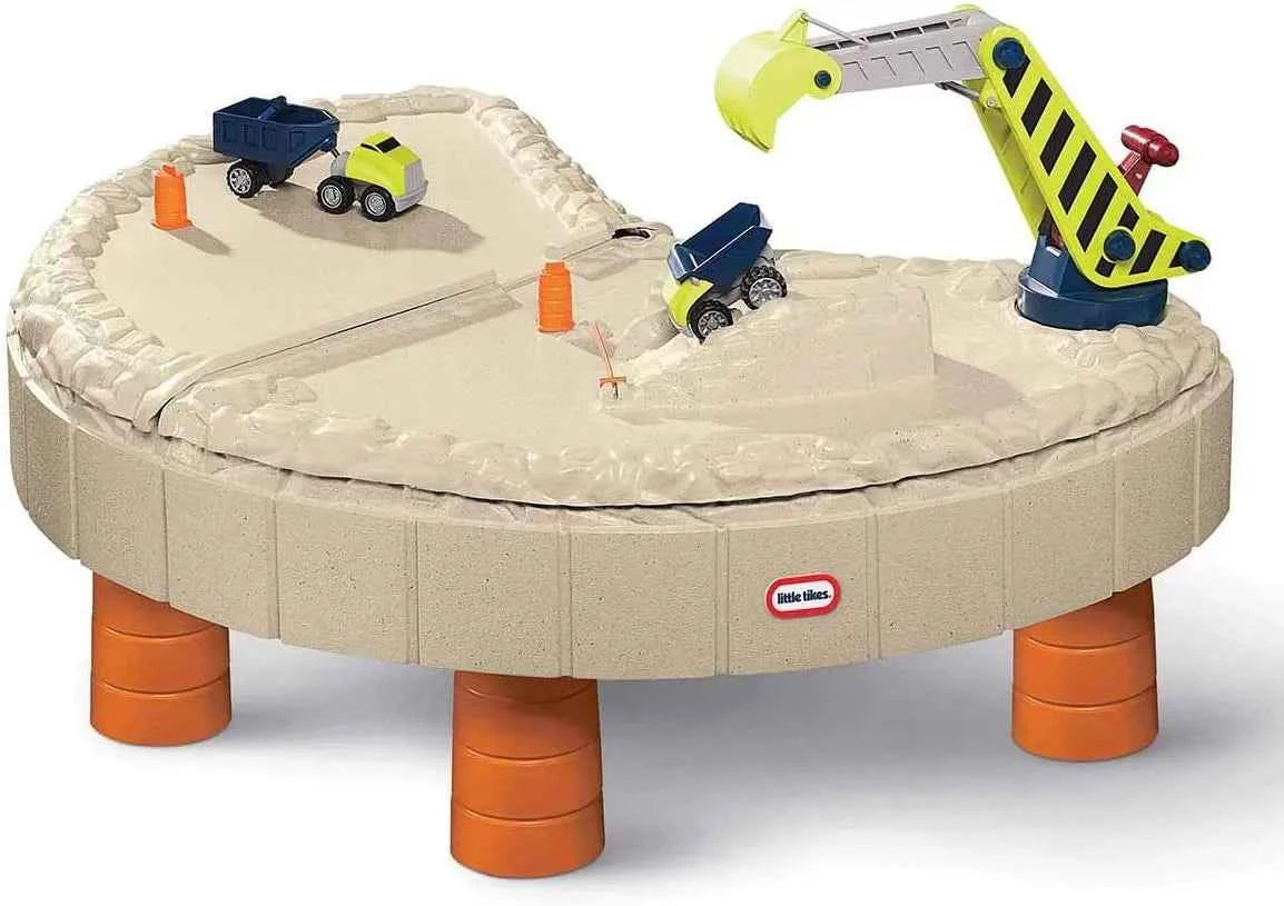 Round construction sand and water table with orange support legs and toys