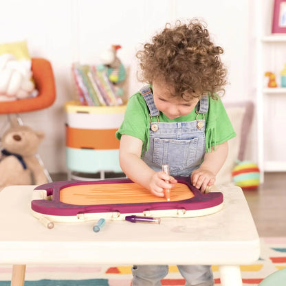Portable water doodle drawing board with purple tray and pen, shown in use by a child
