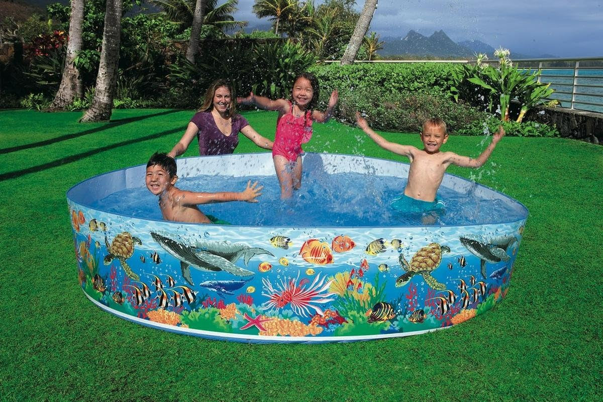 Inflatable paddling pool with coral reef ocean print, kids playing in blue water