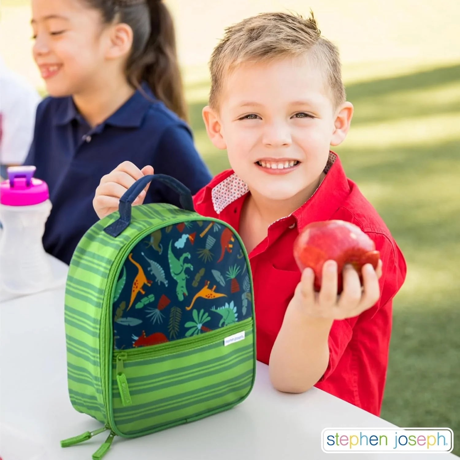Kids transportation print lunch box, green mesh side pocket and blue front zipper.