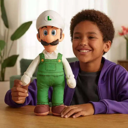 Luigi plush figure in green overalls, white L cap, held beside a smiling child