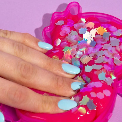 Pink translucent axolotl Play-Doh Super Stretch container held in hand with star confetti