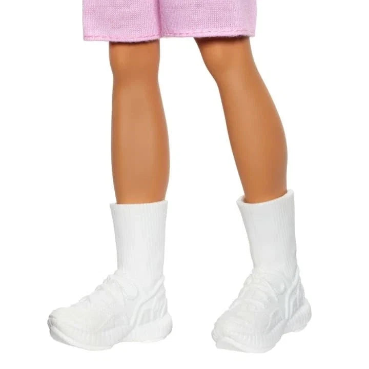 Doll legs in pink shorts with white knit socks and molded white boots
