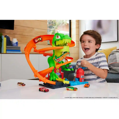 Hot Wheels T-rex track set with orange spiral, green dinosaur, and toy cars
