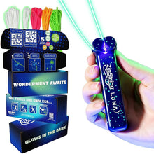 Glow-in-the-dark Zipstring Luma string launcher toy, blue body in hand with green string