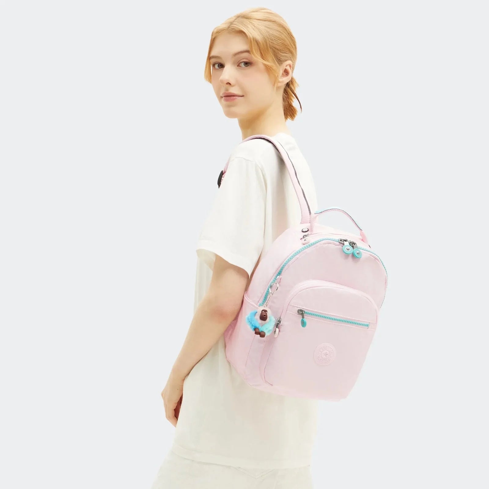 Kipling Seoul mini backpack in sea pink metallic with turquoise trim and front zip pocket