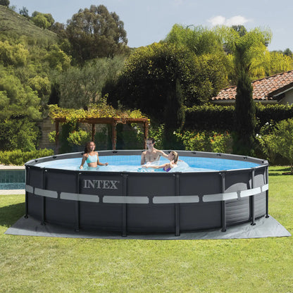 Round INTEX frame pool with blue liner, dark frame, and gray base mat on grass