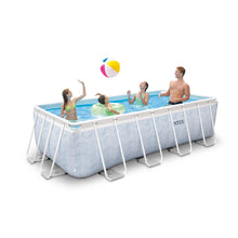 Rectangular above-ground pool with white metal frame and light blue chevron liner