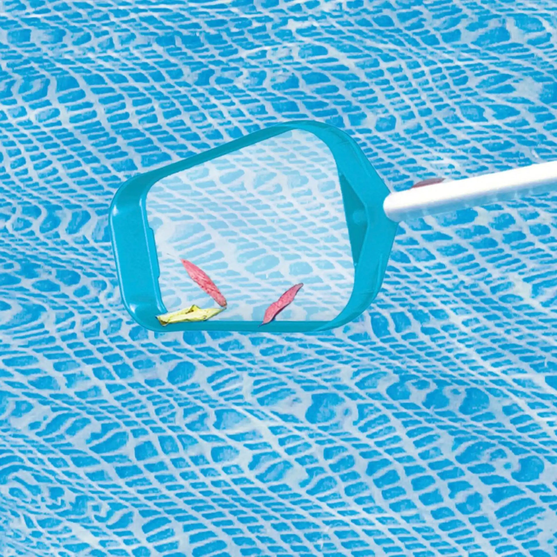 Pool skimmer net with teal frame and white handle on pool surface