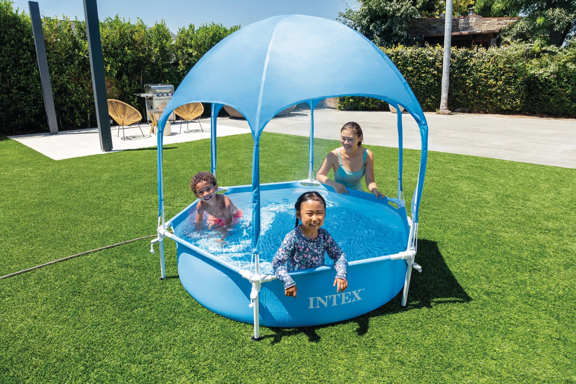Blue inflatable pool with canopy tent, ladder step, and standing frame poles