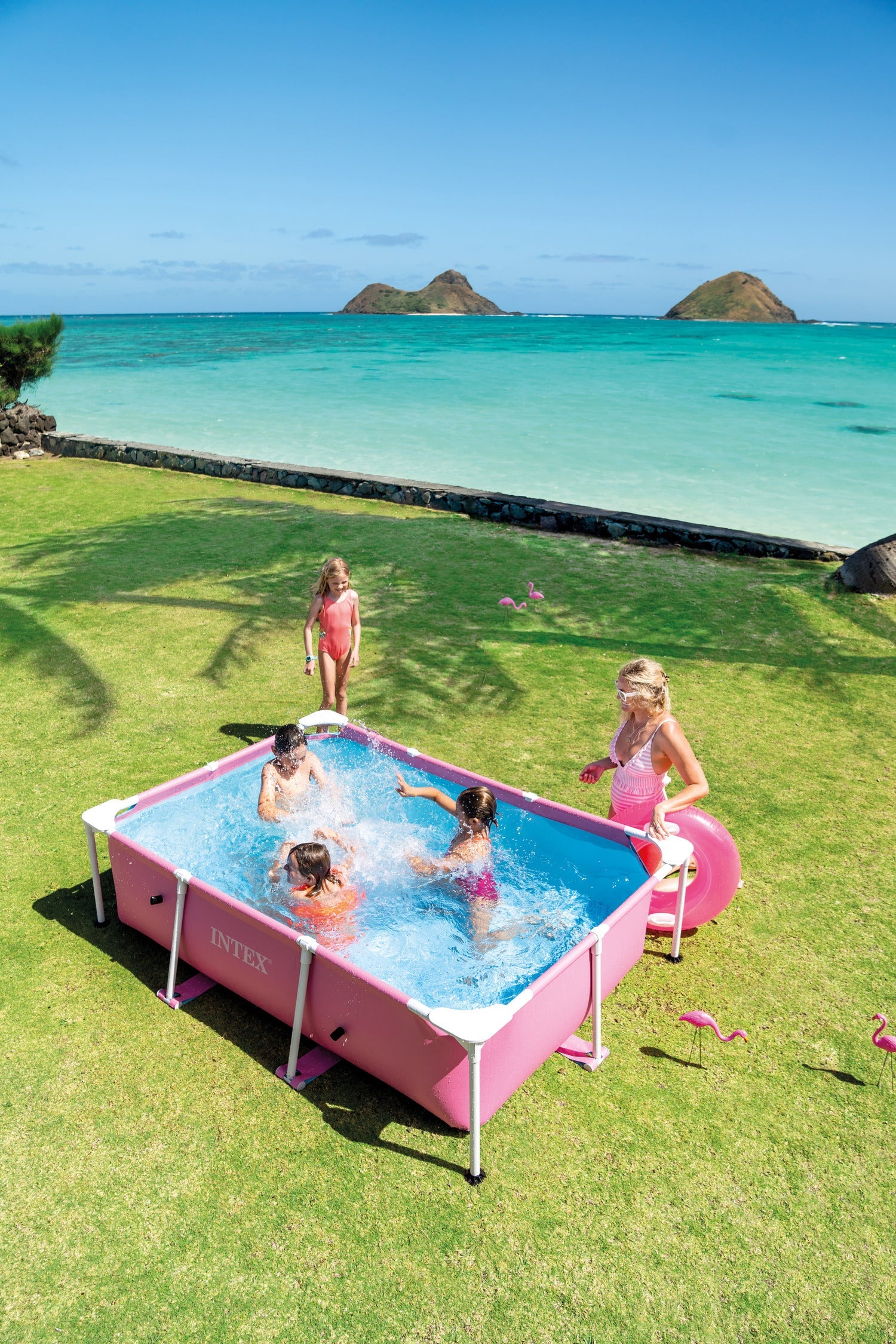 Pink rectangular frame pool with white frame bars, kids splashing in the water