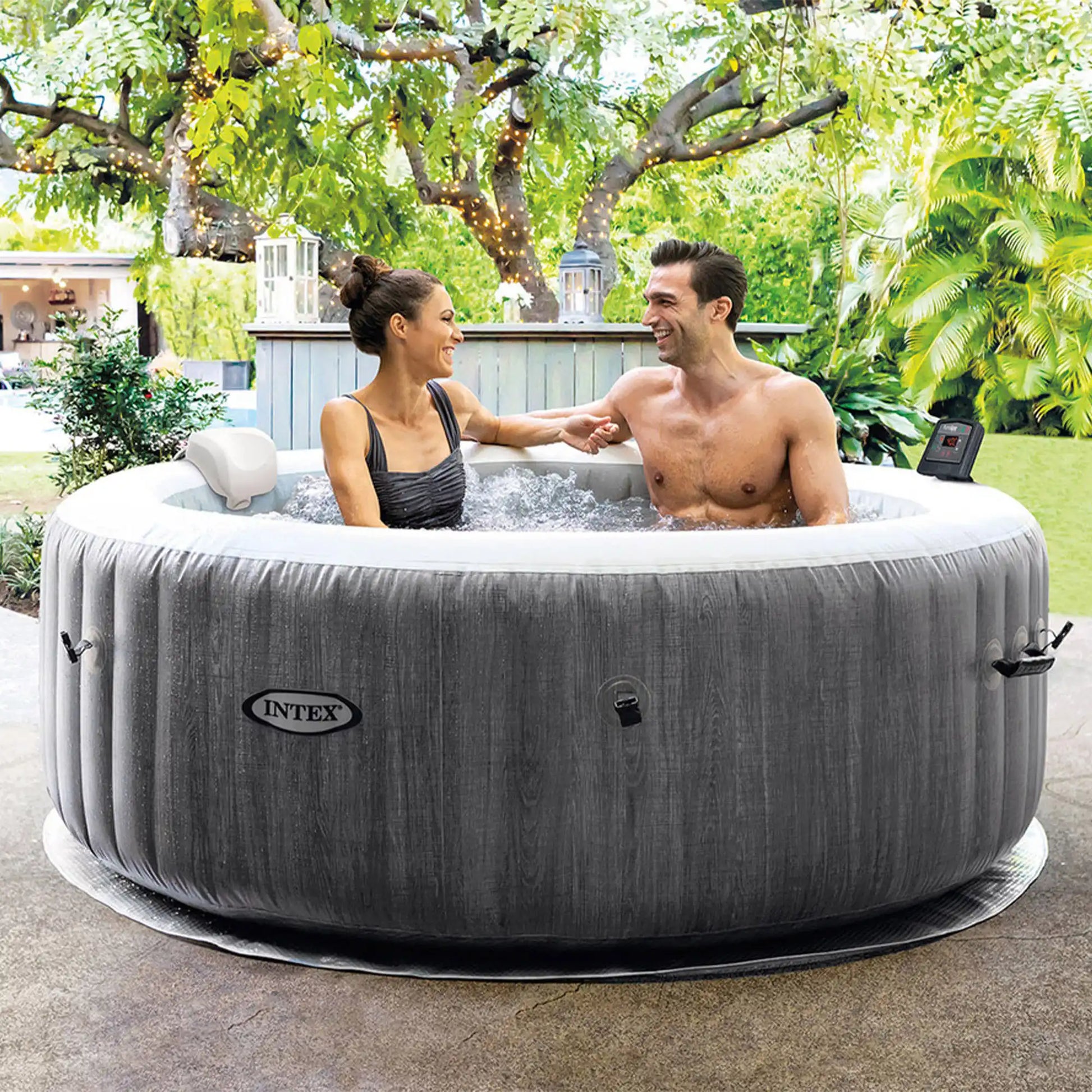 Gray round inflatable hot tub with white rim; two people chatting in the water
