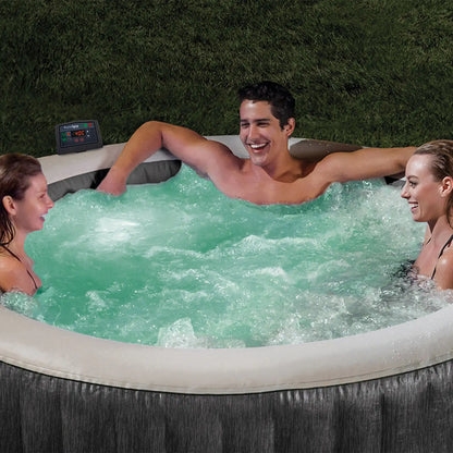 Gray round inflatable hot tub with white rim; people relaxing in bubbling water