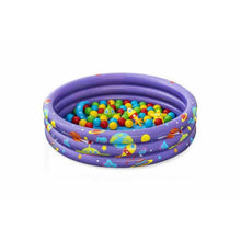 Purple inflatable paddling pool filled with multicolored balls, top view