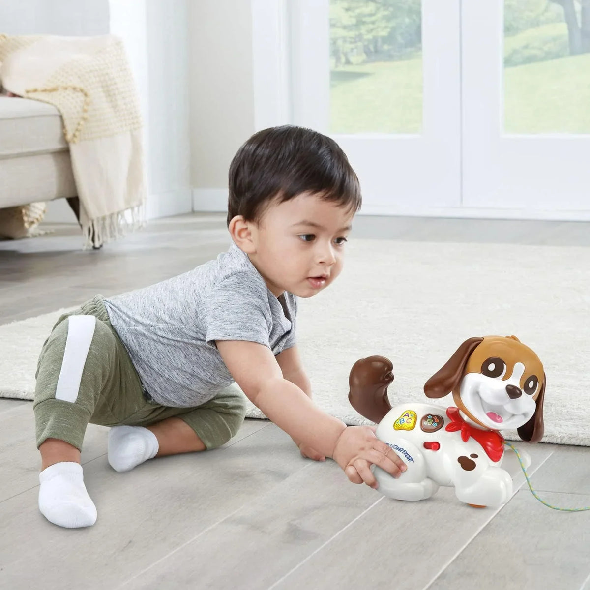 White and brown puppy toy with pull string extended, colorful buttons, red collar