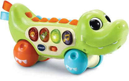 Green pull-along crocodile toy with moving wheel base, colorful button panel and eyes