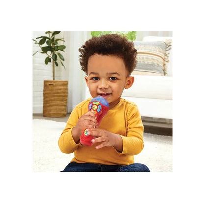 Kids singing toy microphone in a child's hand, red handle and blue button panel