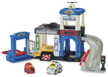 Police station playset with blue building, two toy cars, and a traffic light accessory