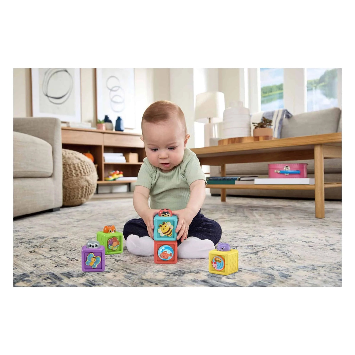 Baby playing with animal cube pop-up toy blocks on a living room floor