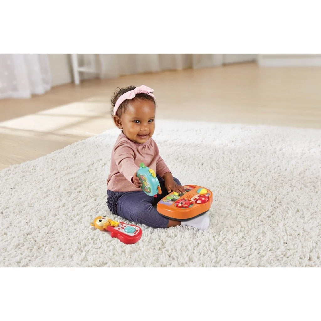 Baby playing with orange animal-themed musical band toy on carpet