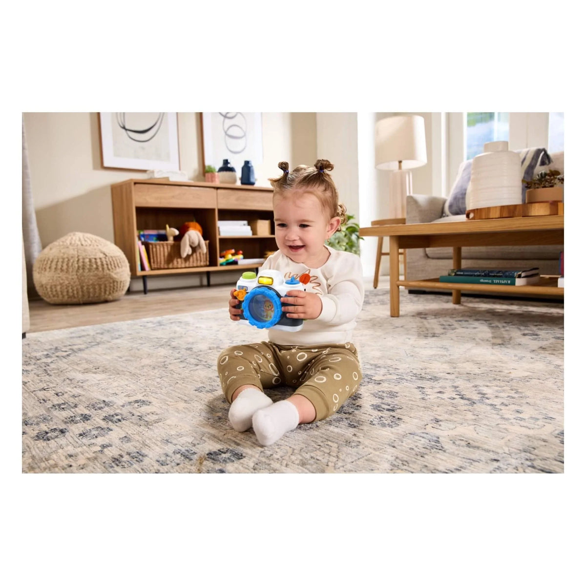 Kids' VTech snap-and-smile camera in blue, held by a smiling child