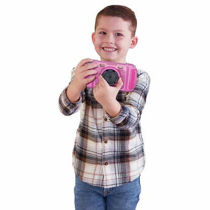 Child holding a pink Kidizoom digital camera with screen and wrist strap