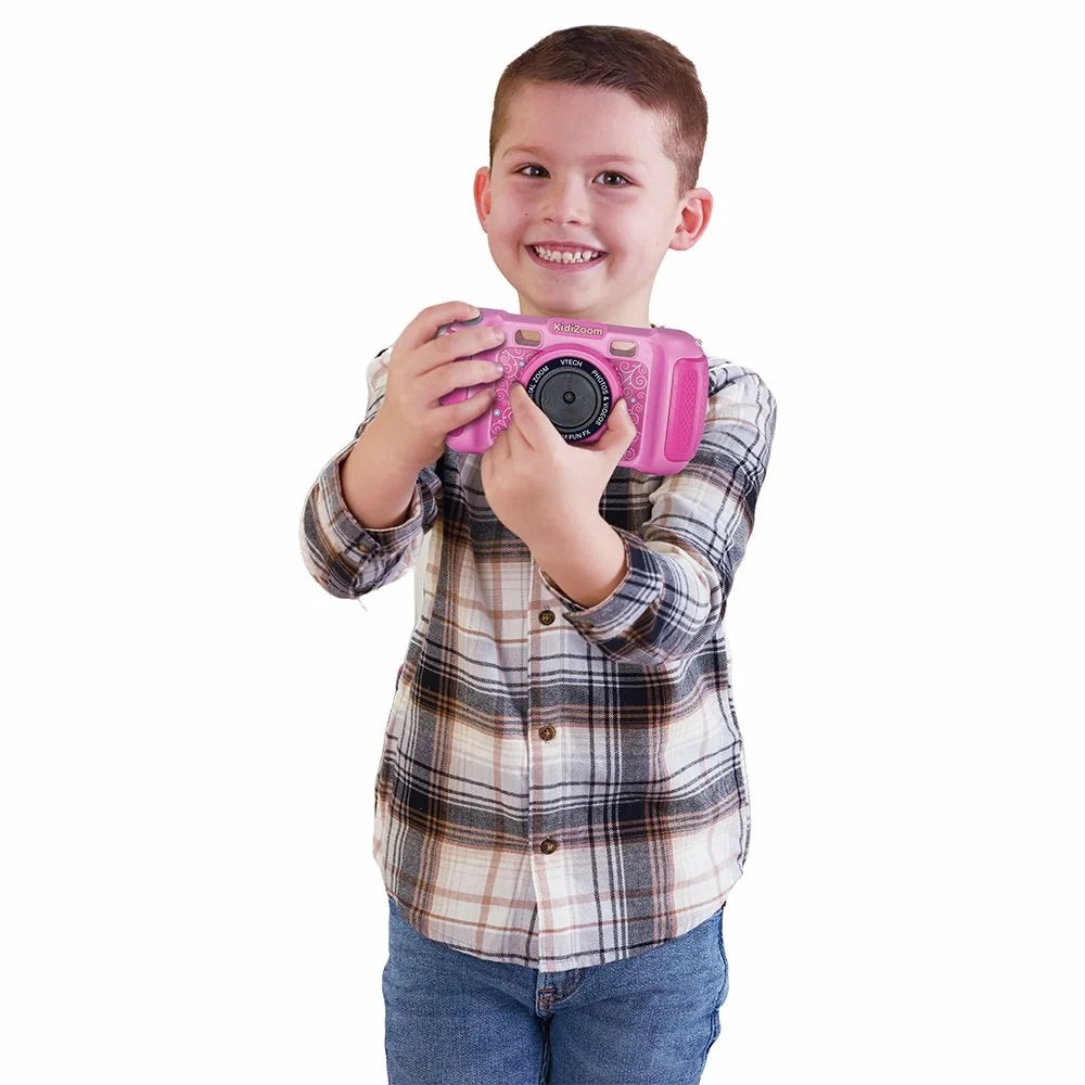 Pink kids digital camera held by a child in front view