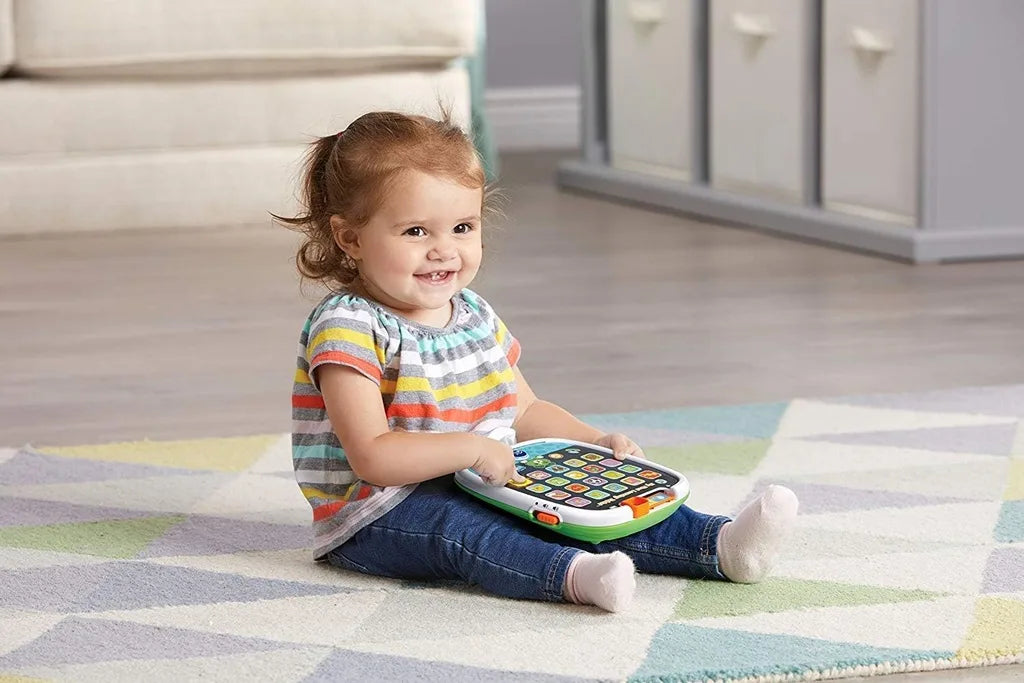 Kids learning tablet toy with colorful icon buttons, held by a toddler