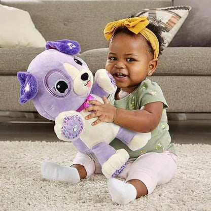 Purple plush dog toy with big eyes, smiling muzzle, and soft paw-print details