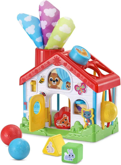 Colorful plastic playhouse toy with doors, animal faces, and sorting shapes, red roof