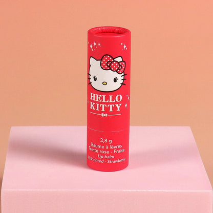 Red Hello Kitty tinted lip balm tube labeled 3.8 g, strawberry pink tint