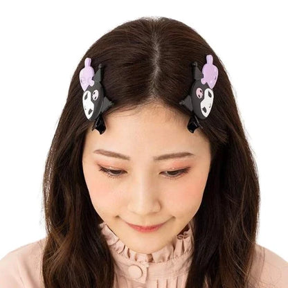 Kuromi themed hair clips, two black cat-face clips with purple accents, worn on hair