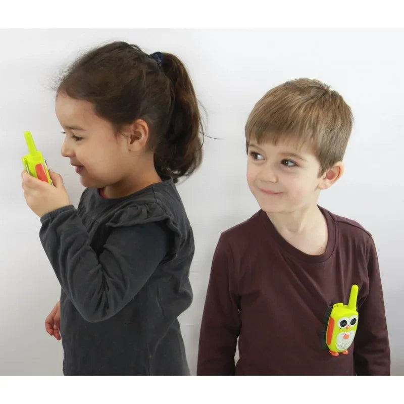 Junior walkie talkies held by children: green penguin design with antenna and speaker grille