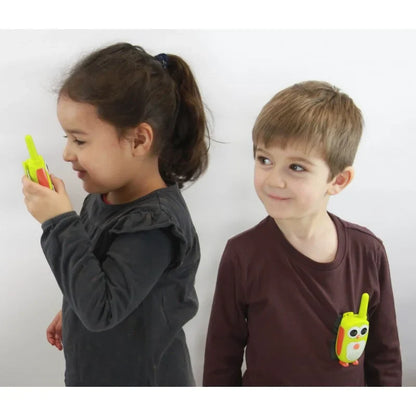 Junior walkie talkies held by children: green penguin design with antenna and speaker grille
