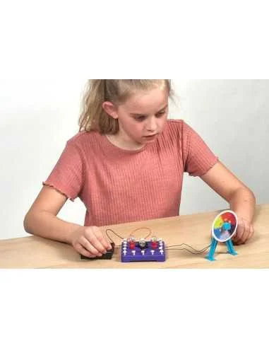 Child using electricity lab kit with blue circuit board and small bulbs