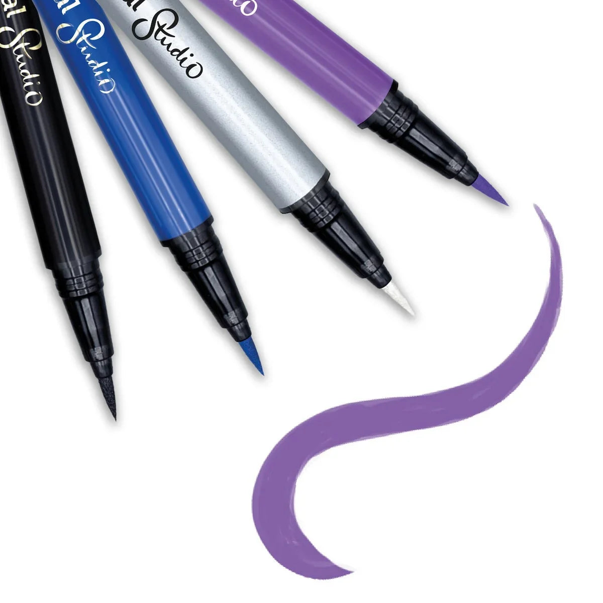 Close-up tattoo ink pens with purple, blue, silver-gray, and black tips; purple line