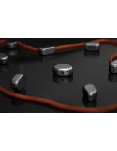 Magnetic game board close-up with orange grooves and silver magnetic pieces