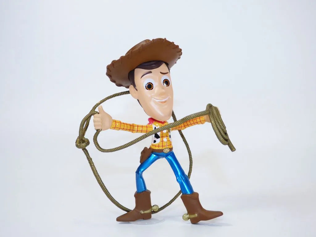 Woody 4-inch metal cowboy figure, brown hat, plaid shirt, blue pants, boots and rope