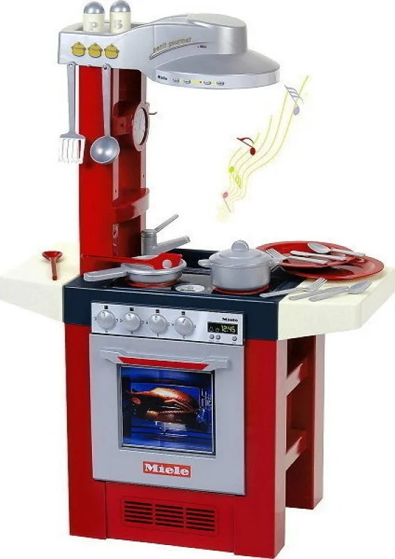 Red and white Miele play kitchen set with oven door, stovetop, and cookware