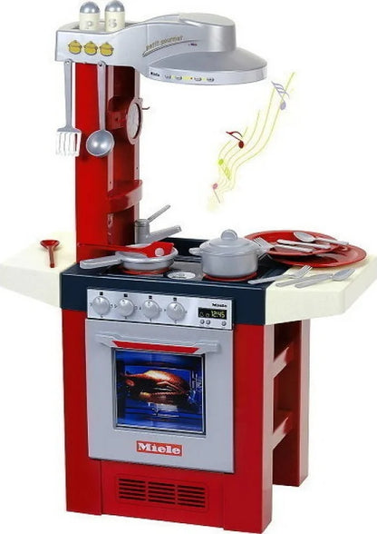 Red and white Miele play kitchen set with oven door, stovetop, and cookware