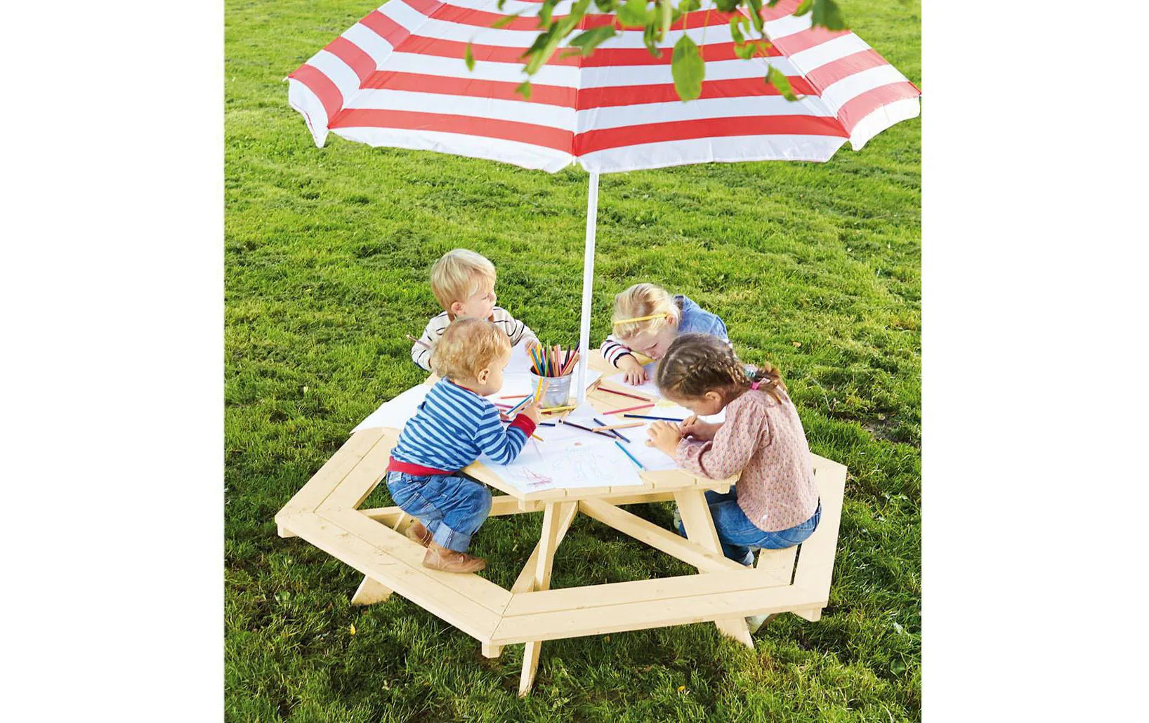 Children's hexagon table and bench set with striped umbrella on grass