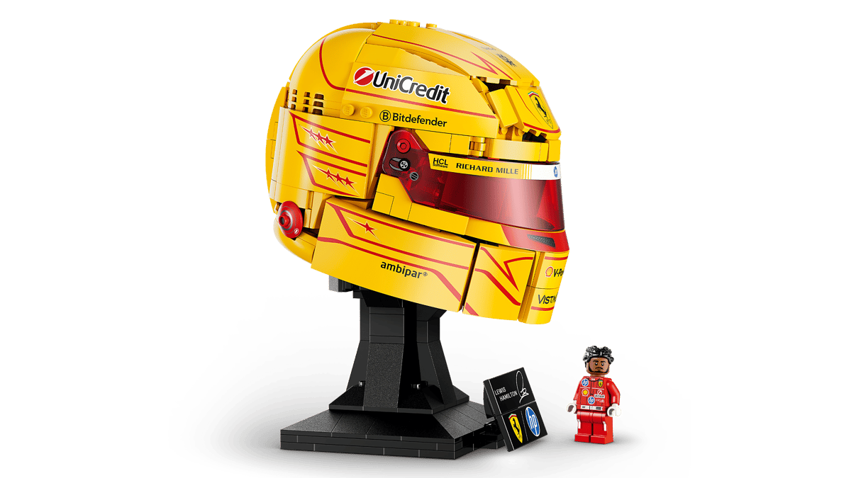 Three-quarter view of yellow racing helmet model on black stand with small figure