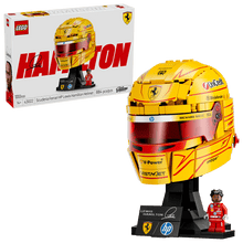 Boxed yellow racing helmet model on display stand with minifigure, front view