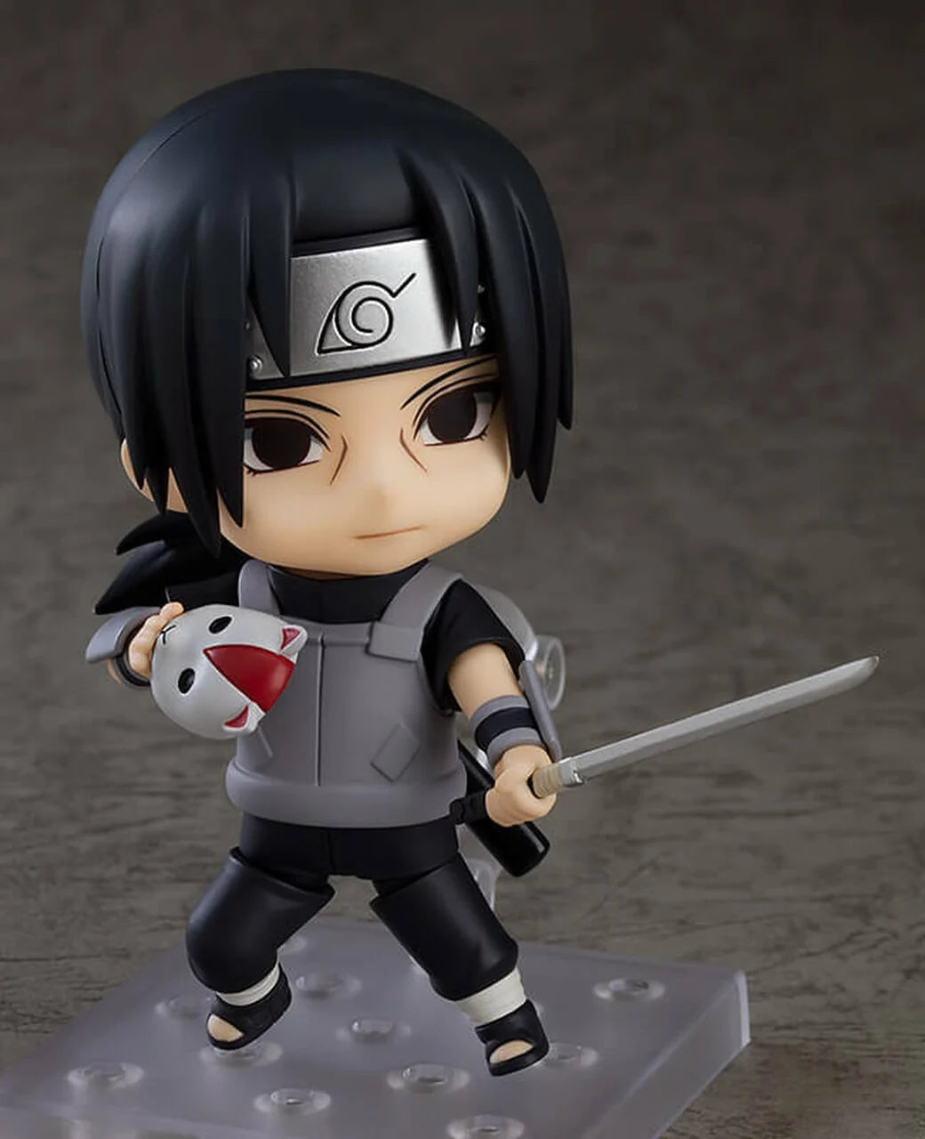 Ninja chibi action figure holding a white-and-red mascot and a sword, gray-and-black ANBU outfit